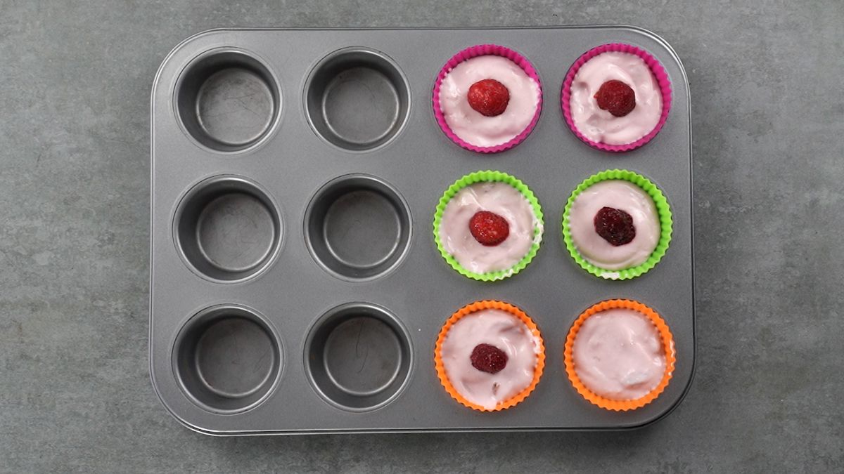 yogurt topped with berries in muffin tin