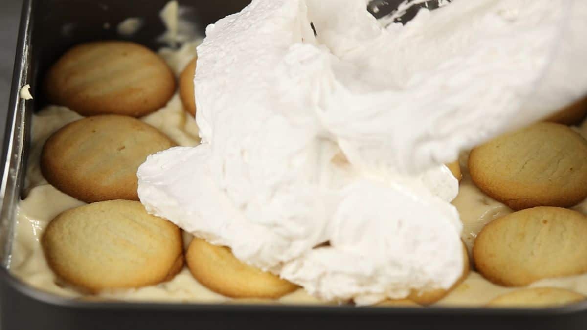 whipped topping over cookies in square pan