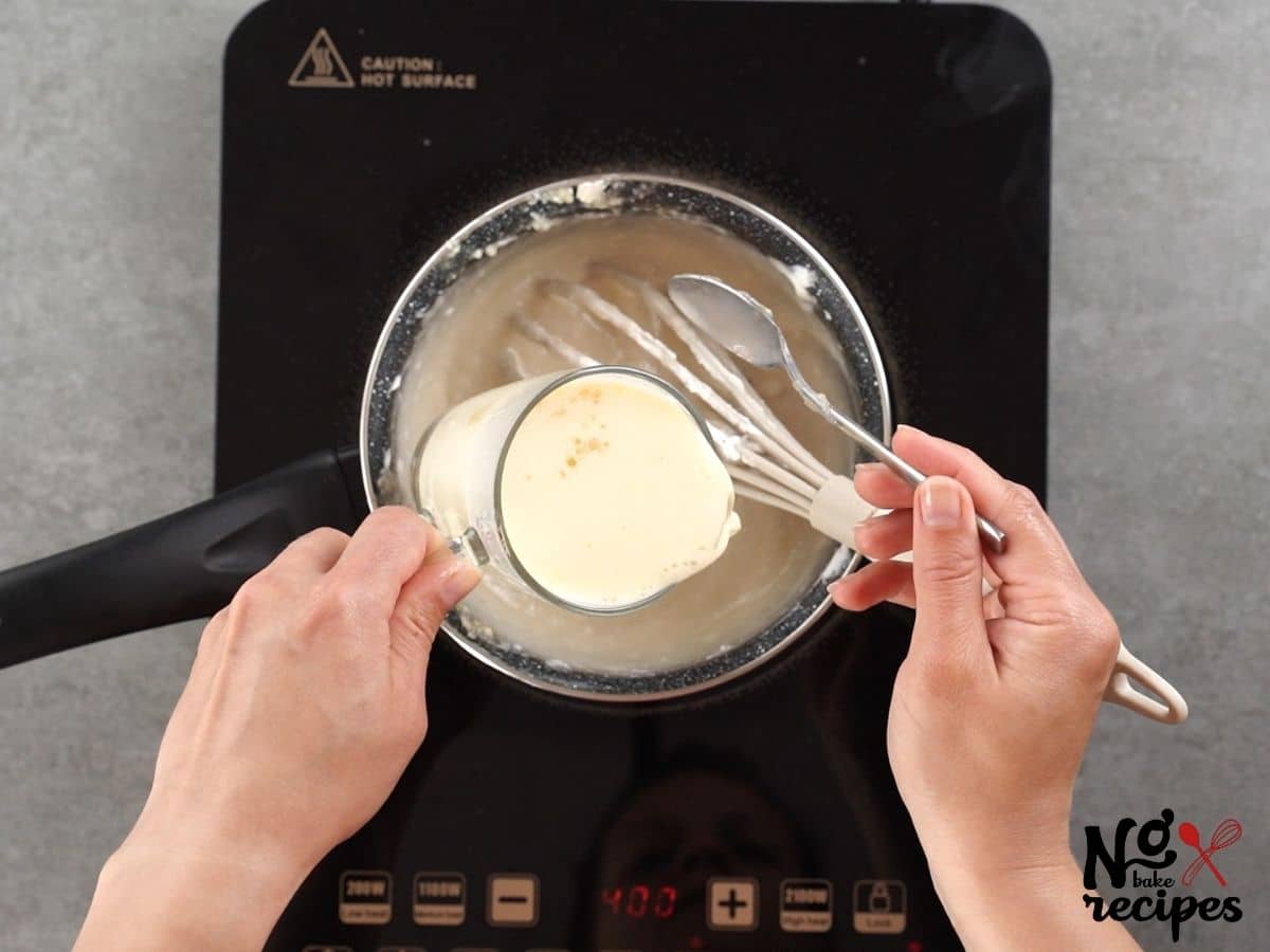 hands pouring milk into saucepan