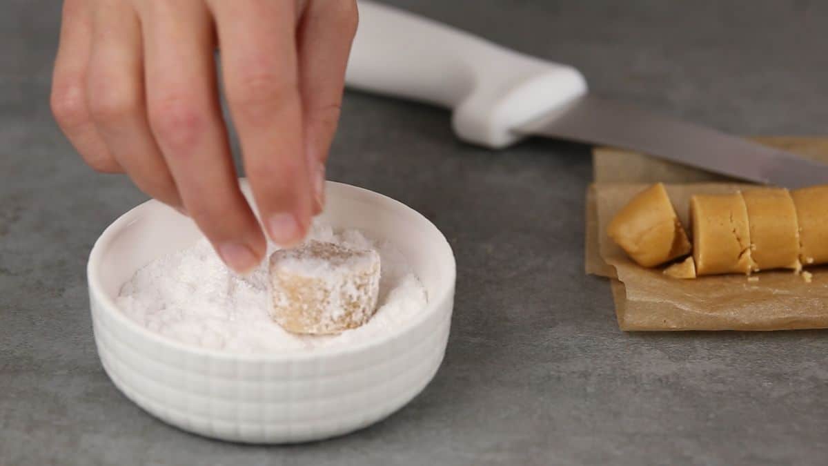 hand rolling candy in powdered sugar