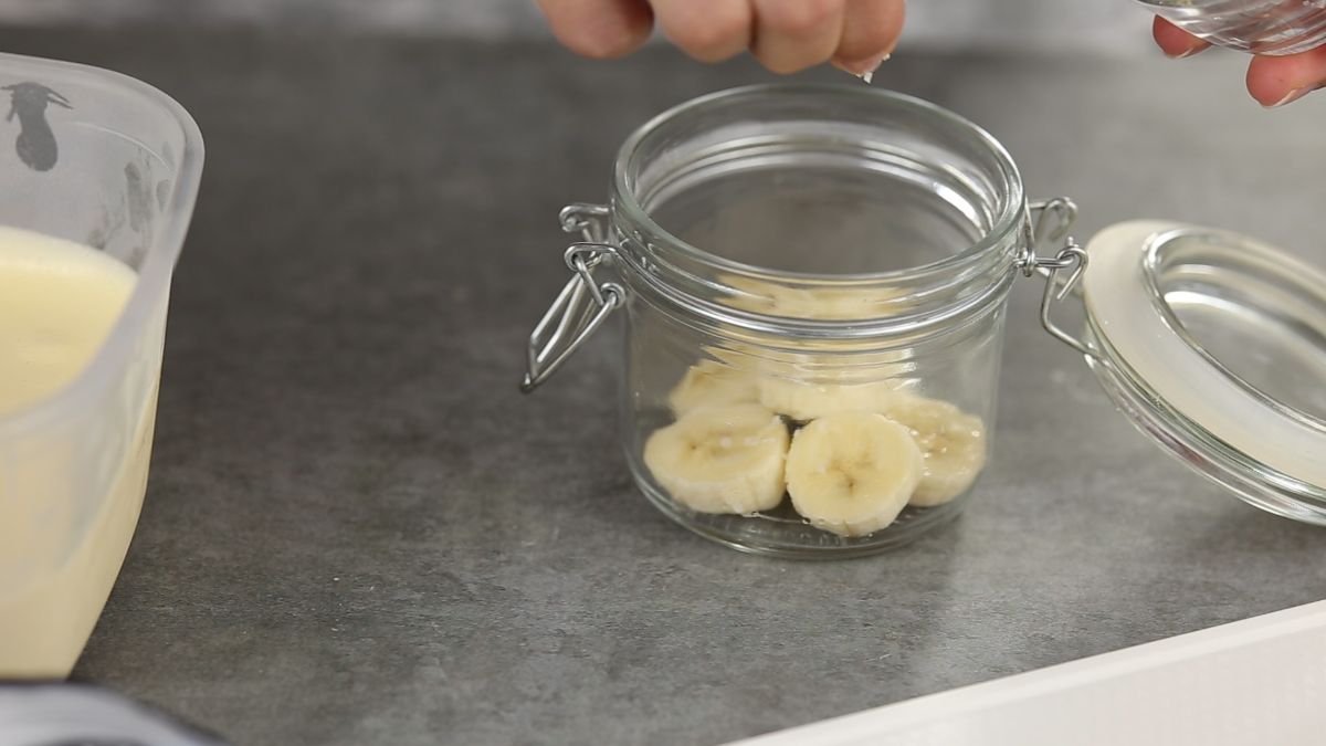 hand putting bananas into ja