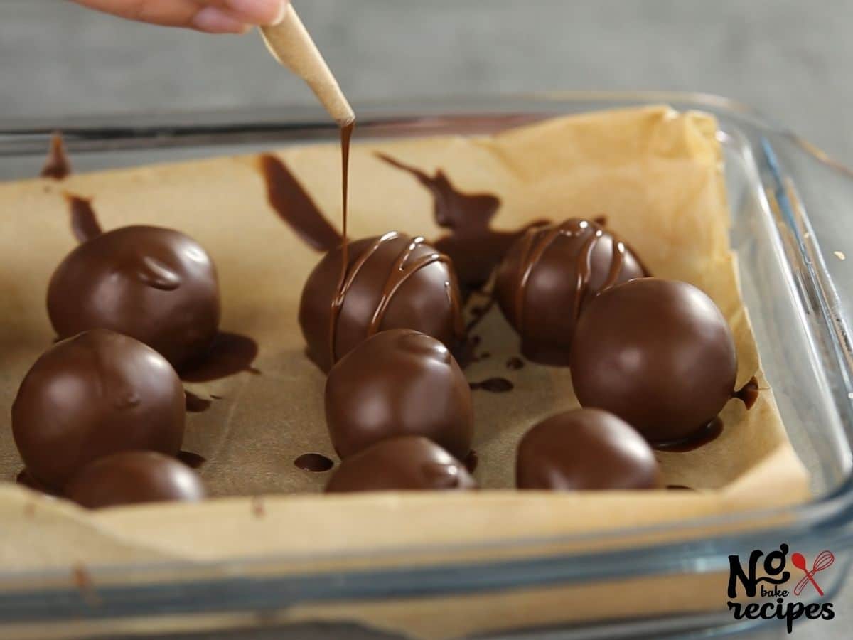 hand drizzling extra chocolate on truffles