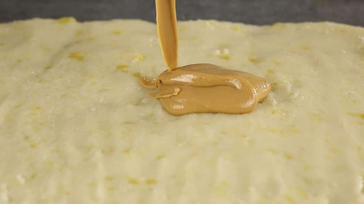 peanut butter being poured onto dough