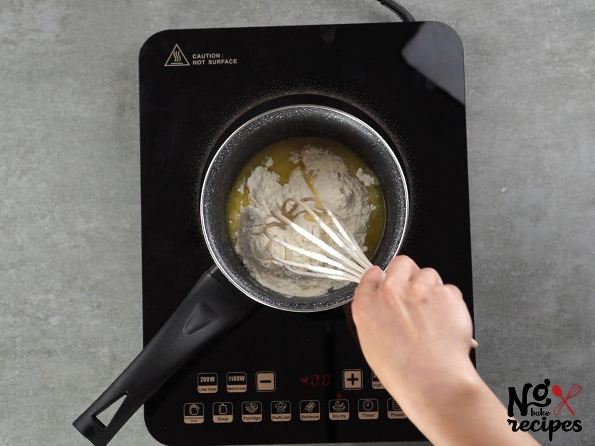 hand whisking flour into butter