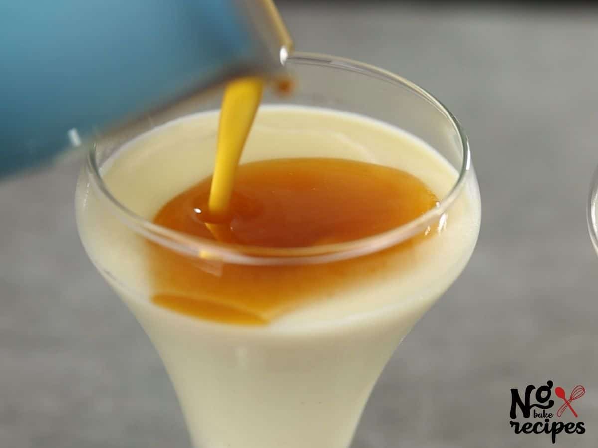 pouring caramel on top of vanilla pudding