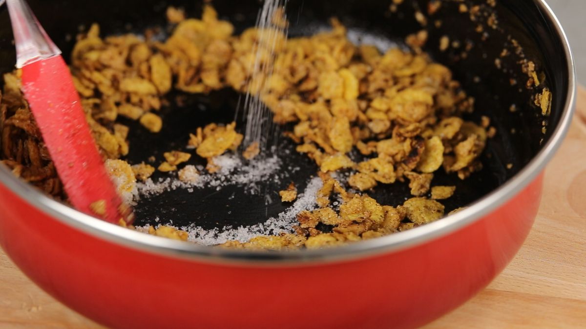 adding sugar to cornflakes and butter