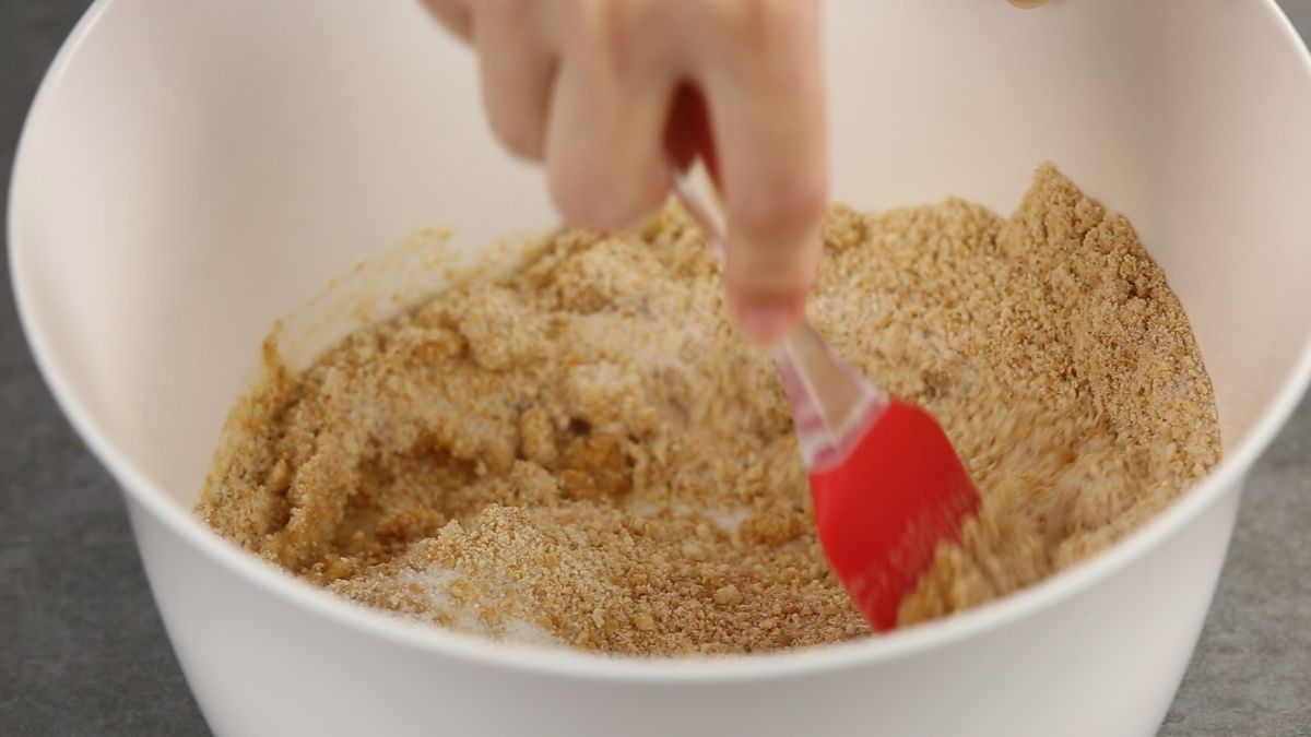 Pour a mixture of crushed graham crackers, butter and sugar as the 1st layer of the pie