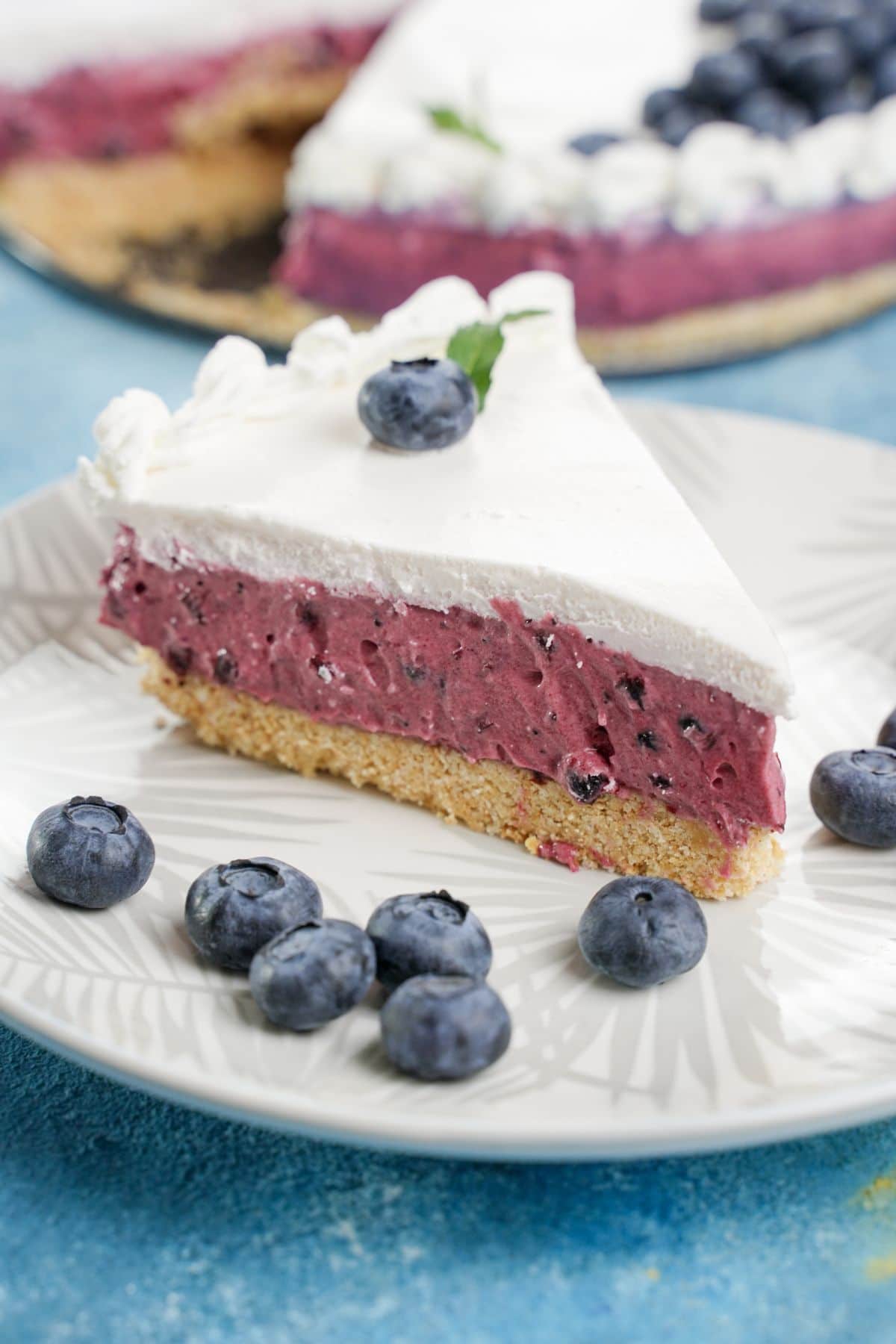 A piece of No-Bake Blueberry Pie served with fresh blueberries