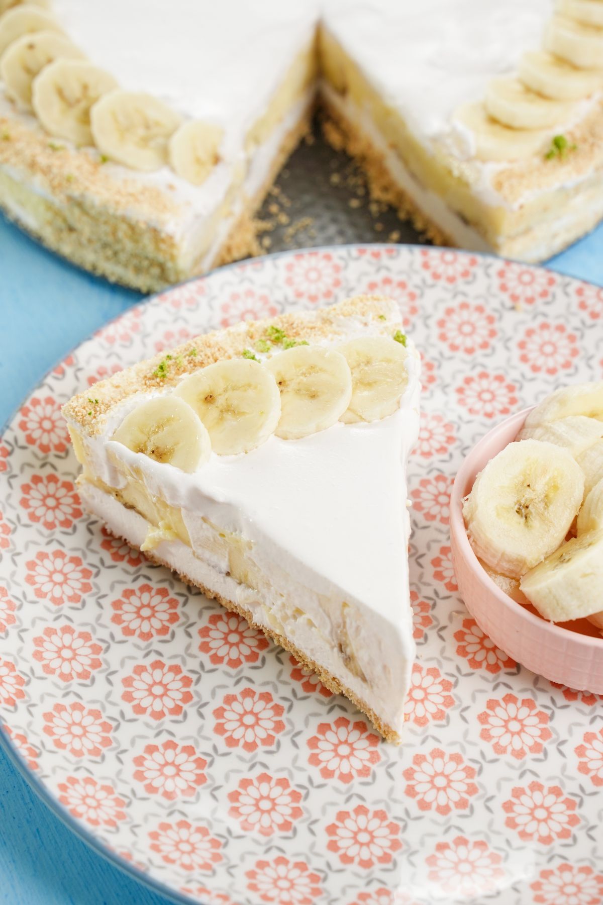 No-Bake Layered Banana Pudding Cake served with fresh bananas