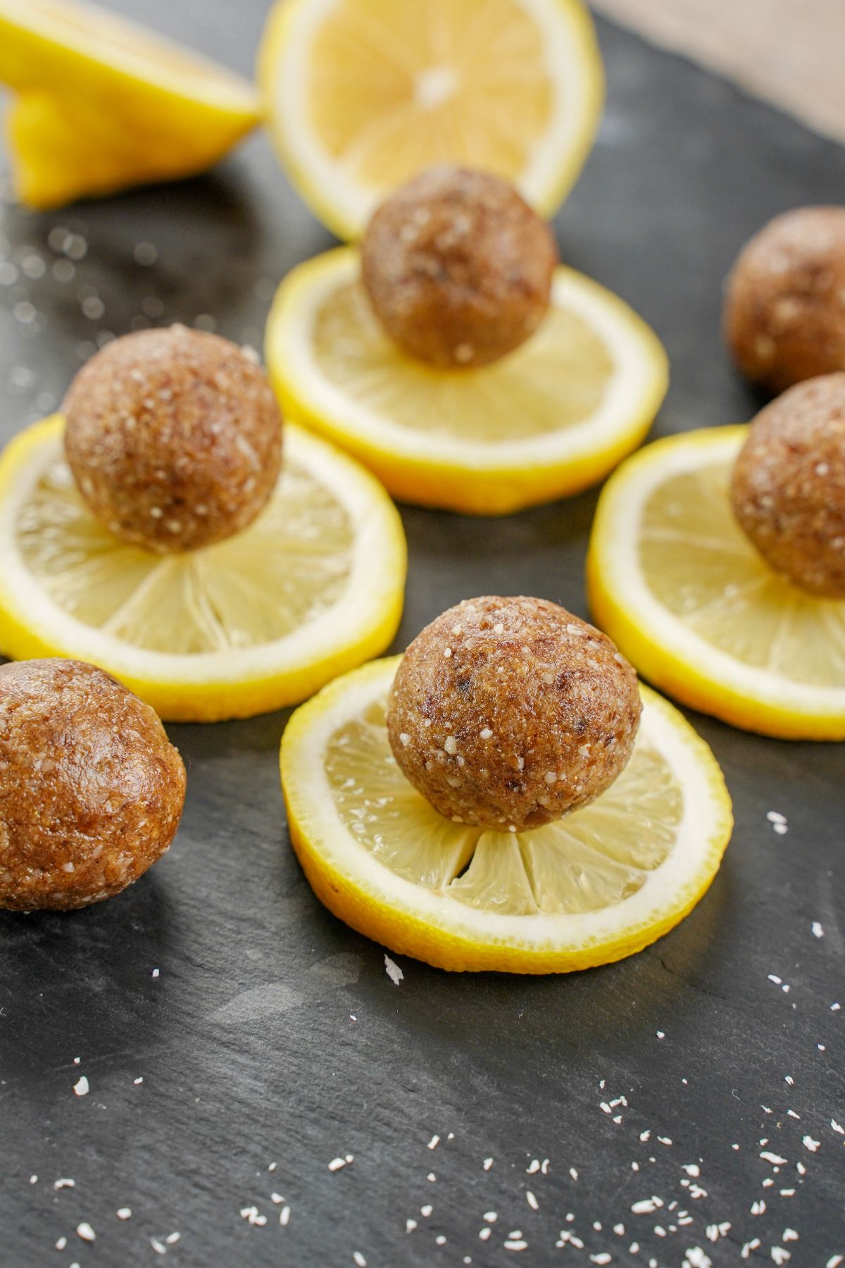 No-Bake Lemon Protein Balls served on a lemon wedges