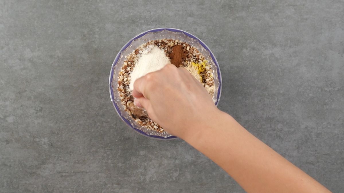 Add vanilla powder, maca powder, cashew butter, cinnamon, & salt to the mixture and grind well