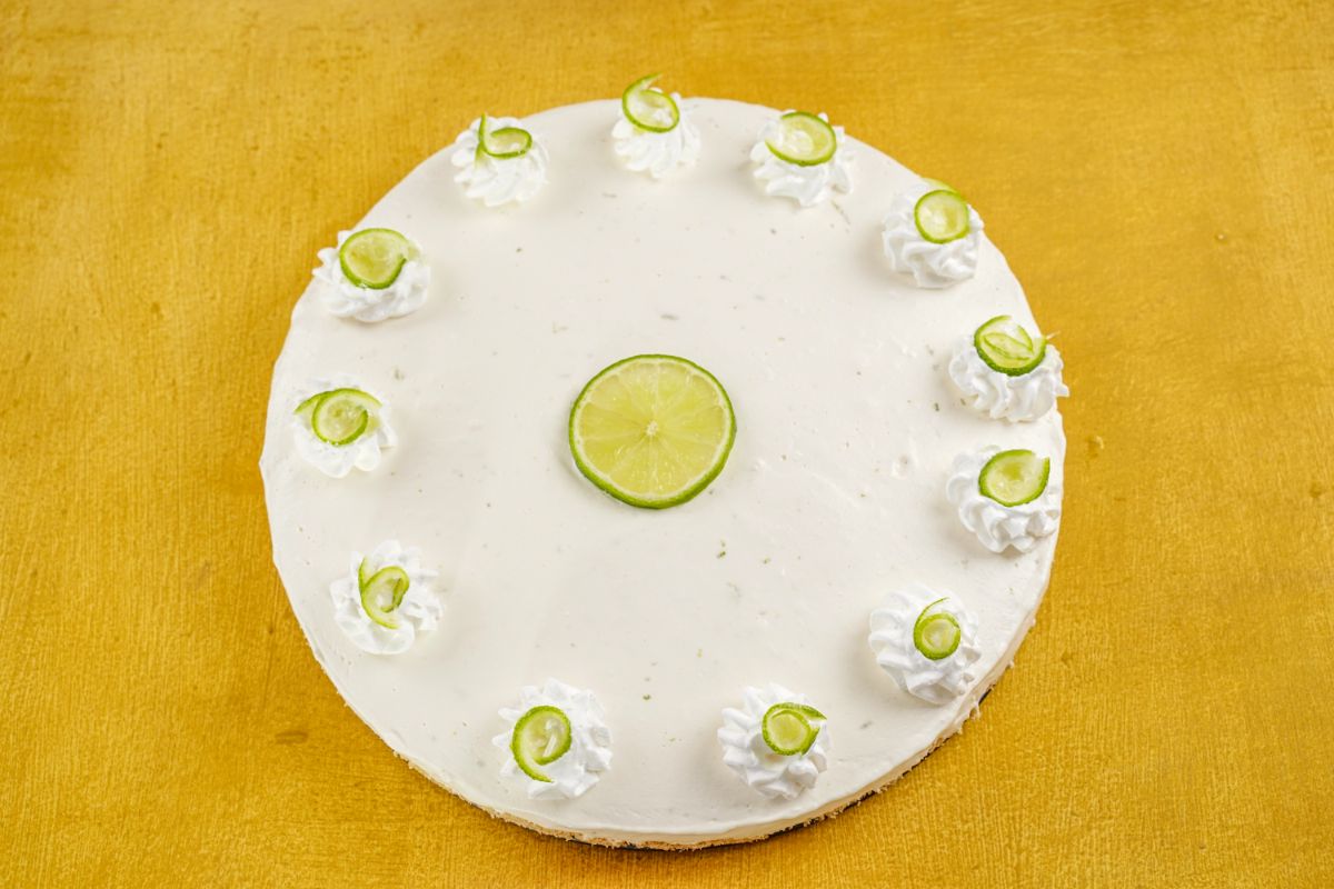 tart with lime slices on top sitting on yellow table