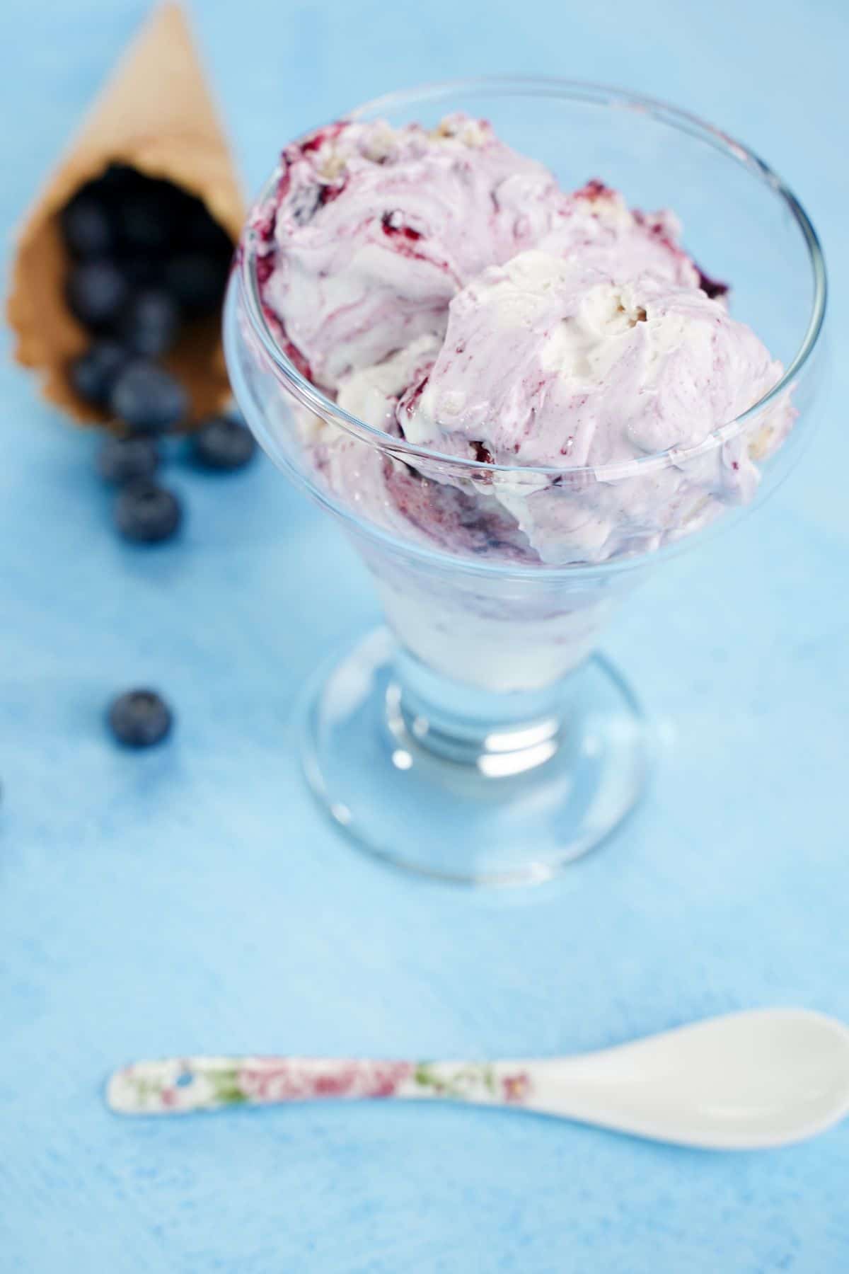 No Churn Blueberry Cheesecake Ice Cream in a dessert glass