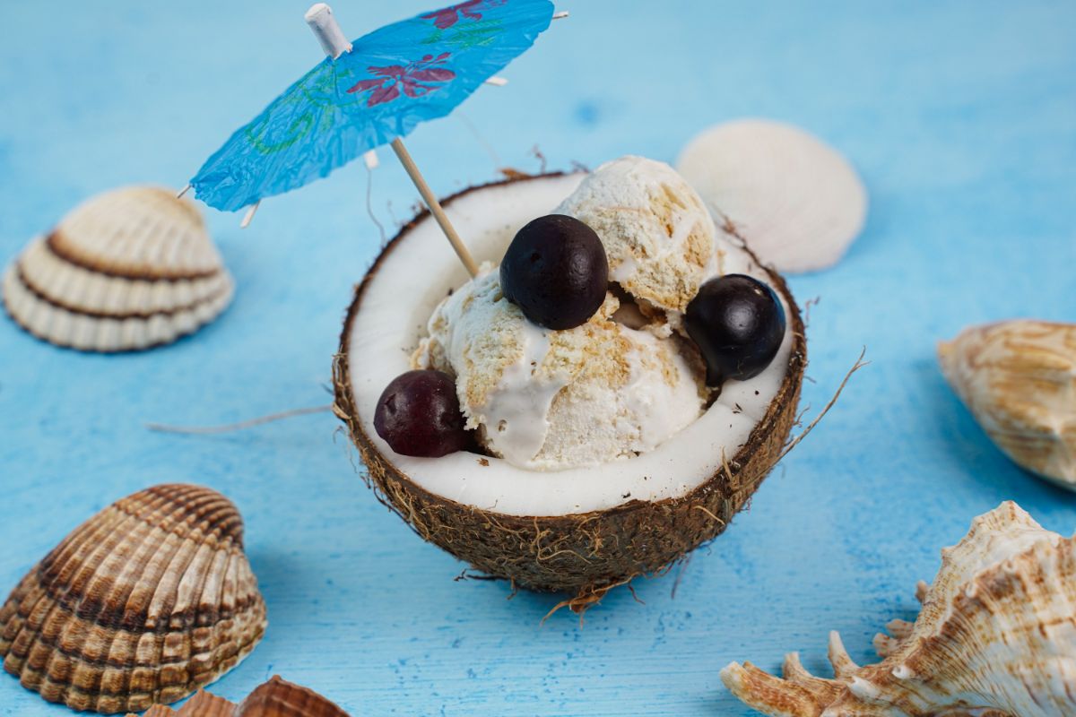 No Churn Cherry Cheesecake Ice Cream served in a coconut 
