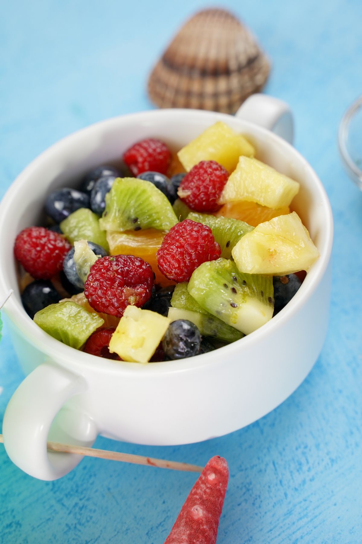 Rainbow Fruit Salad with Honey Dressing served in a cup