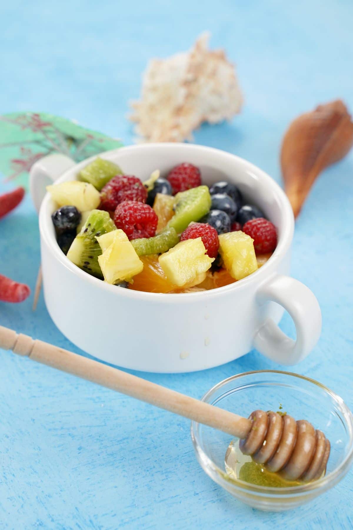 Rainbow Fruit Salad with Honey Dressing served in a fancy bowl