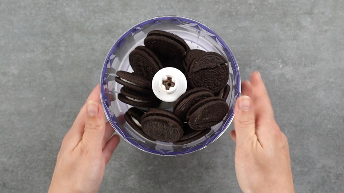 Oreo cookies in food processor on gray table