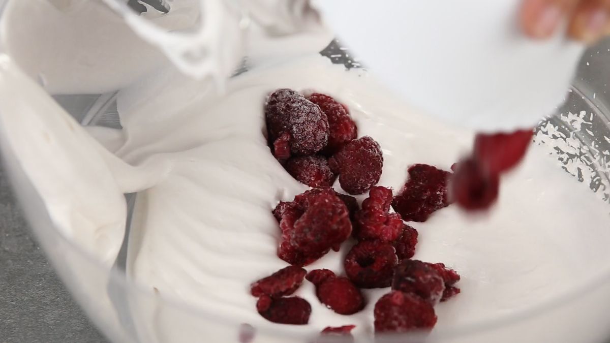 raspberries in bowl of whipped cream