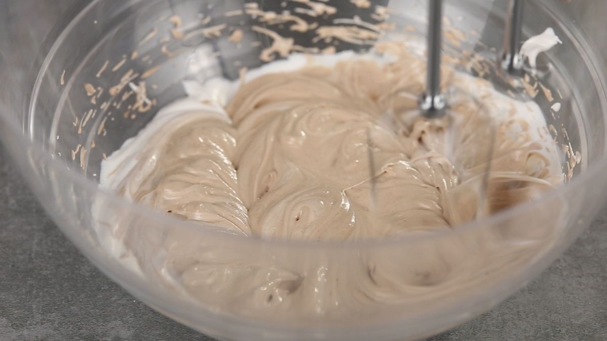 Nutella whipped cream with beaters in large glass bowl