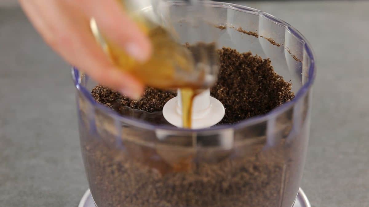 honey being added to chocolate crumbs
