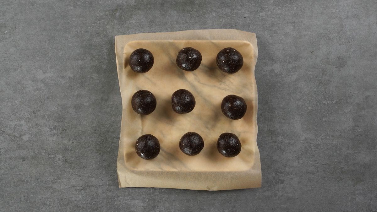 superfood energy bites on parchment paper sitting on grey table