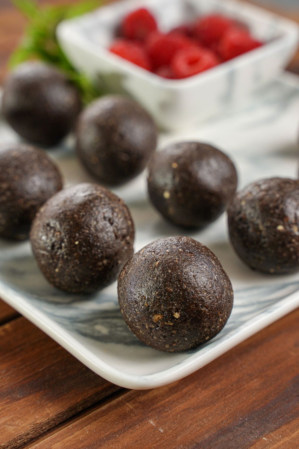 chocolate balls on marble plate on wood table