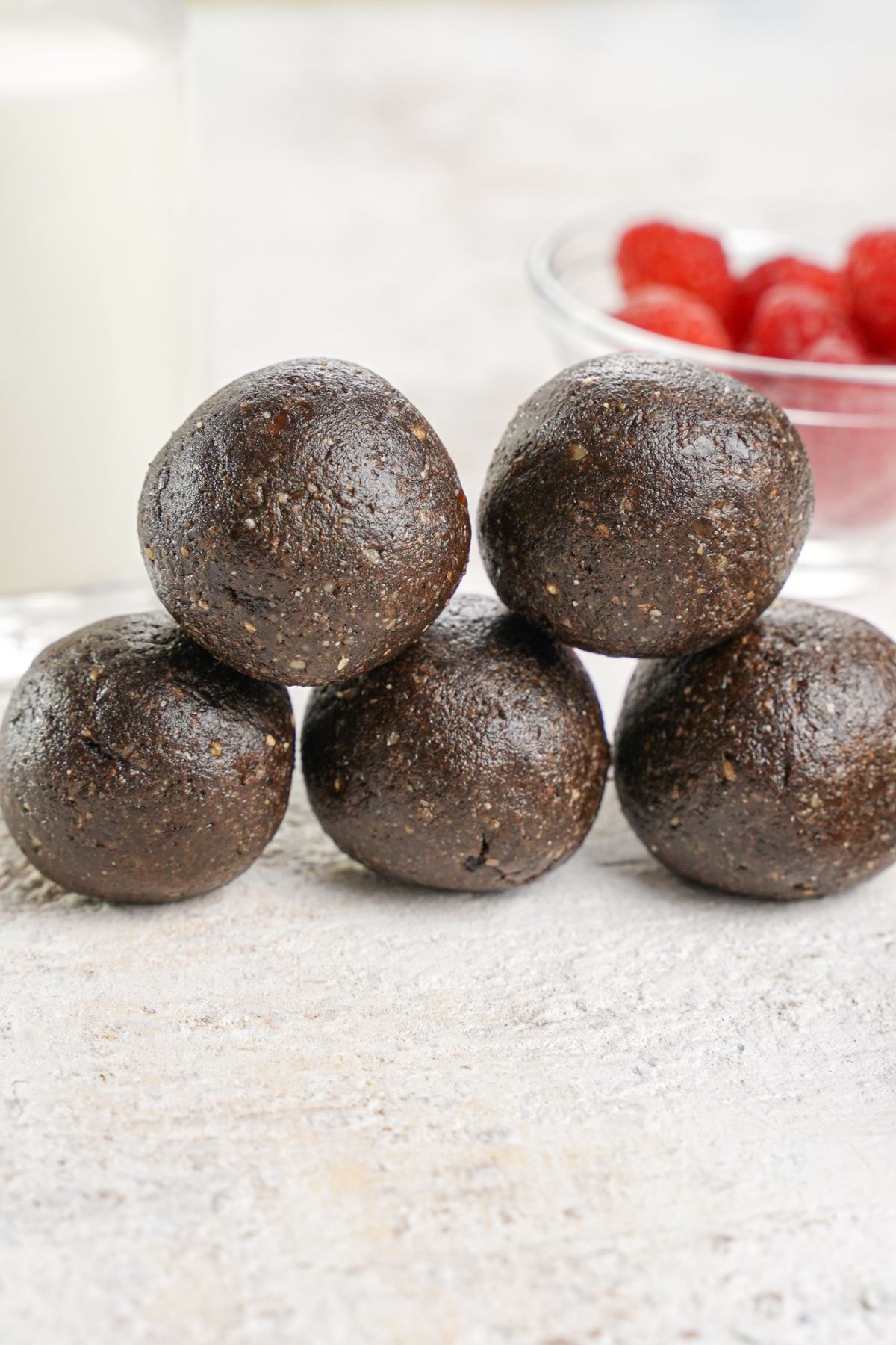 energy balls stacked on top of each other on white table