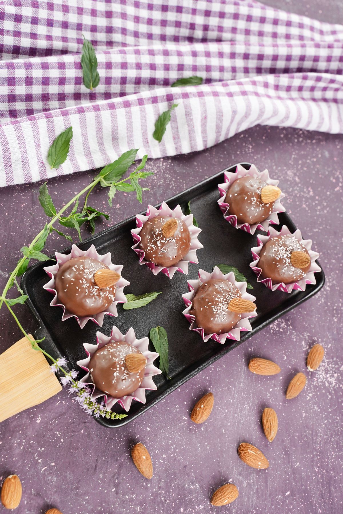 Chocolate Coconut Almond Balls served in a tray with mint leaves and almonds 