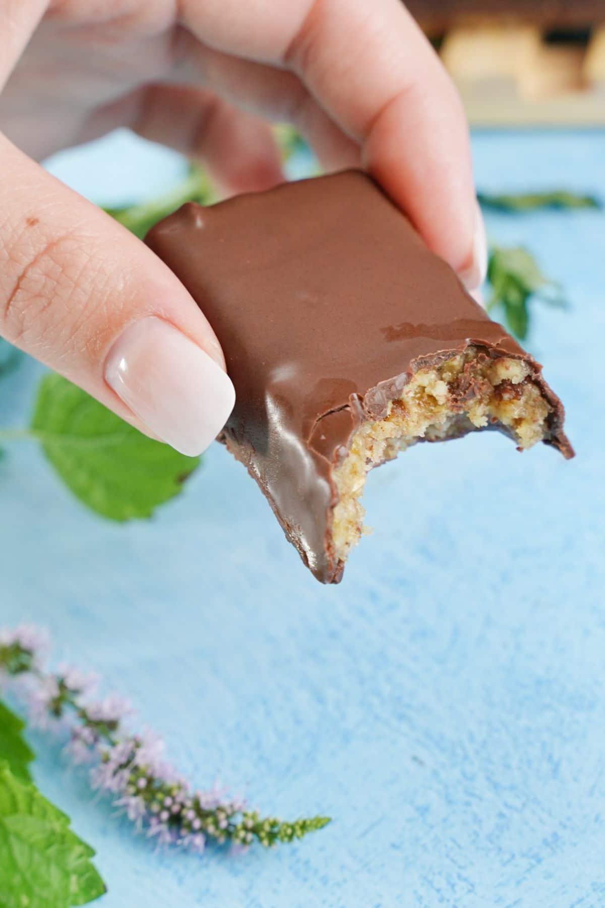 A bite taken from Chocolate Covered Coconut Cashew Bars