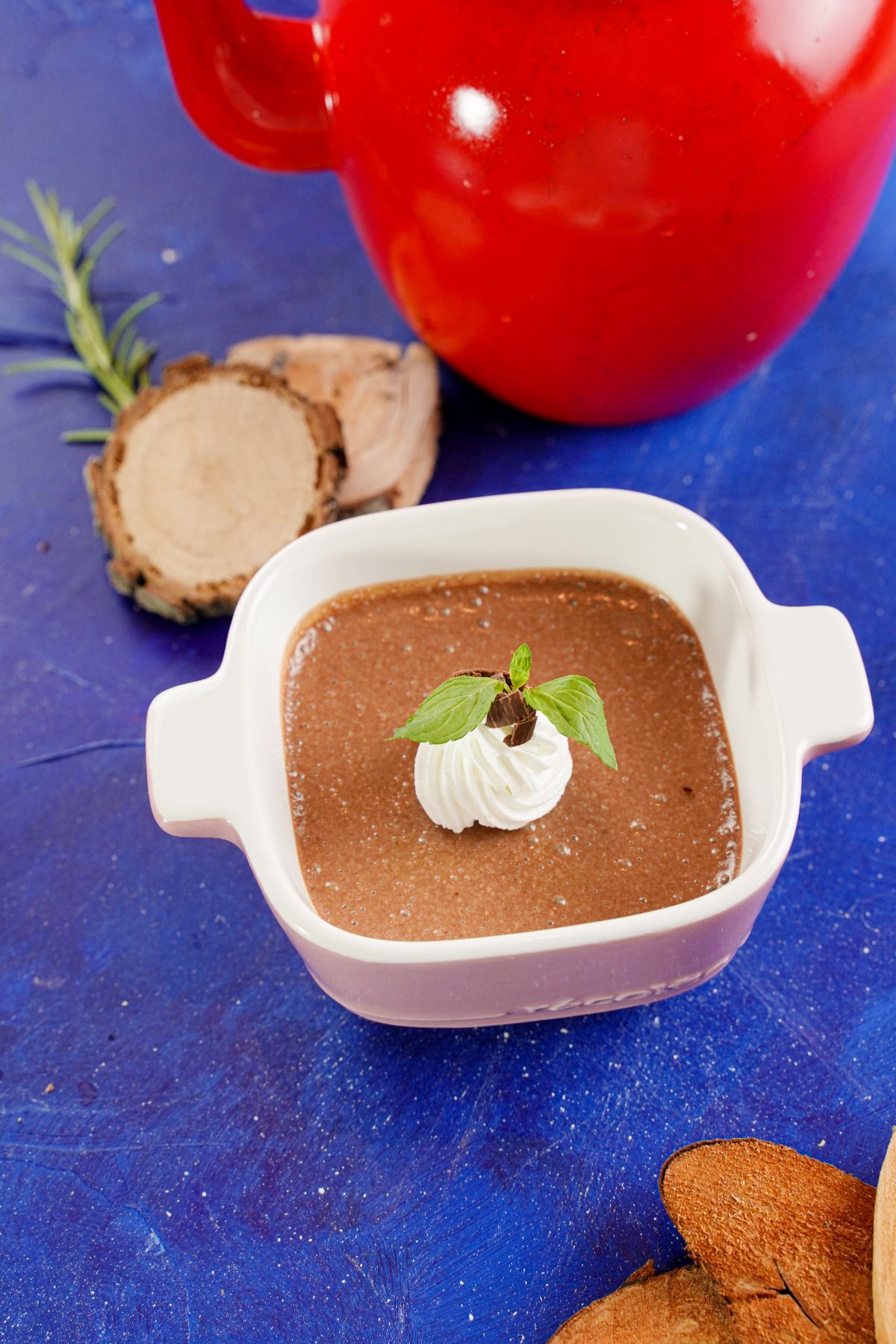 Chocolate Pots de Creme in a bowl with some mint leaves