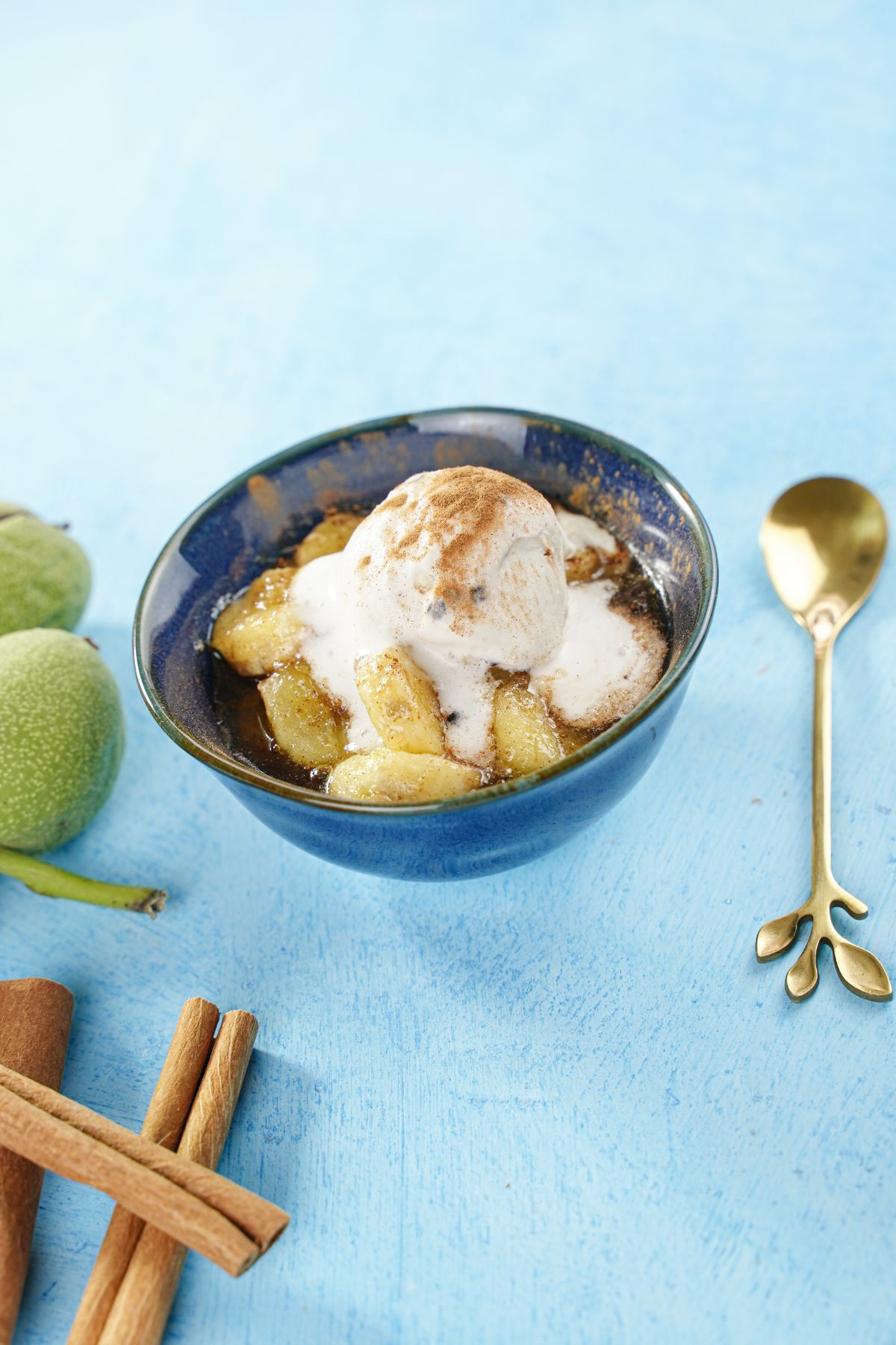 Cinnamon Spiced Bananas served with ice creams in a bowl with a golden spoon