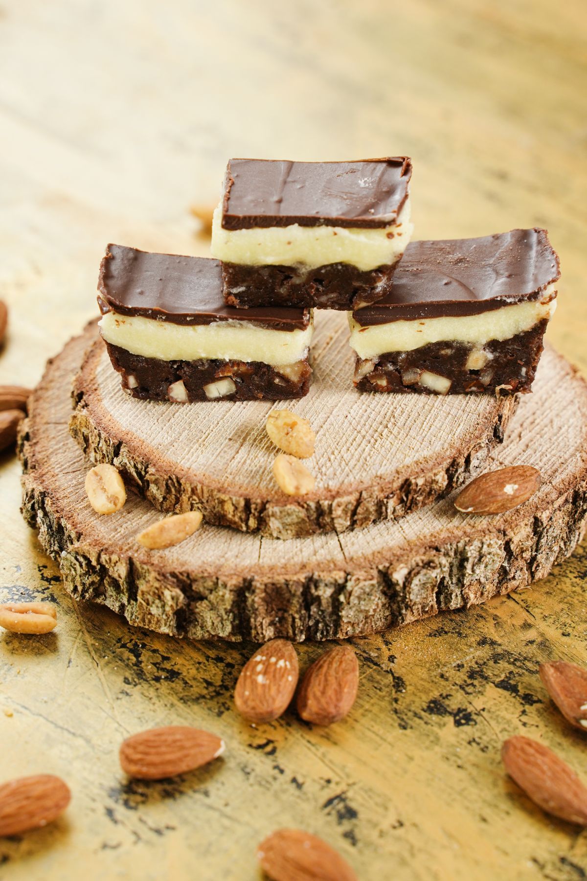 Copycat Nanaimo Bars served on wooden plater