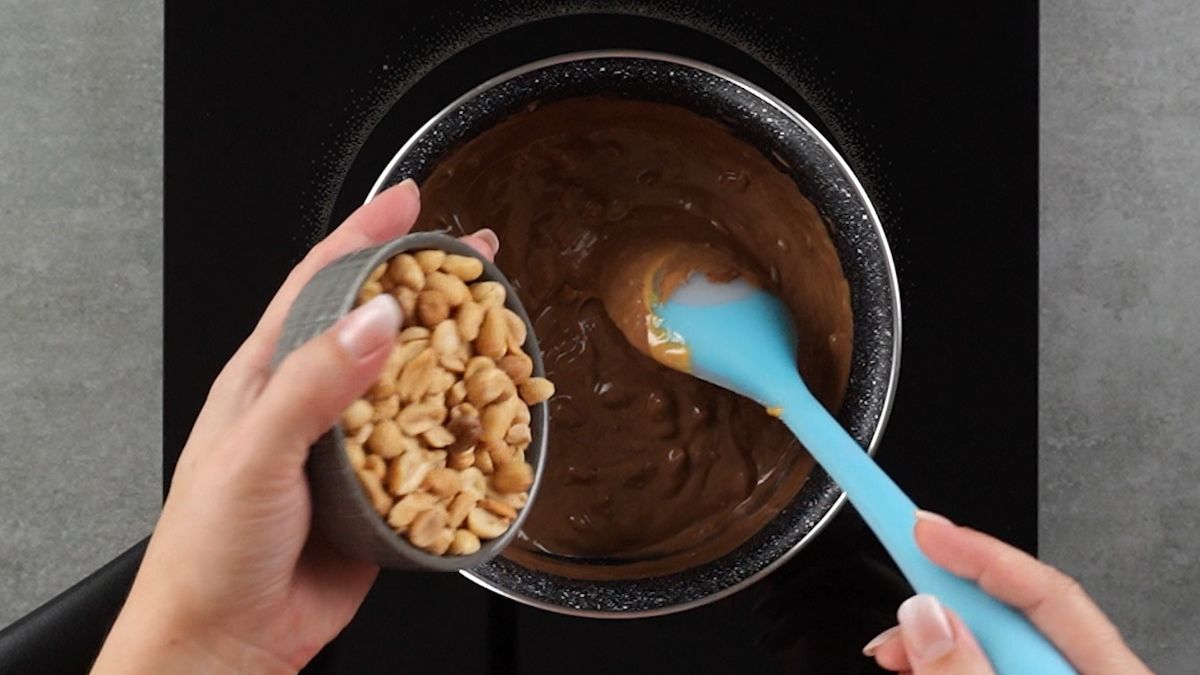 Add butter and salted peanuts to the chocolate 