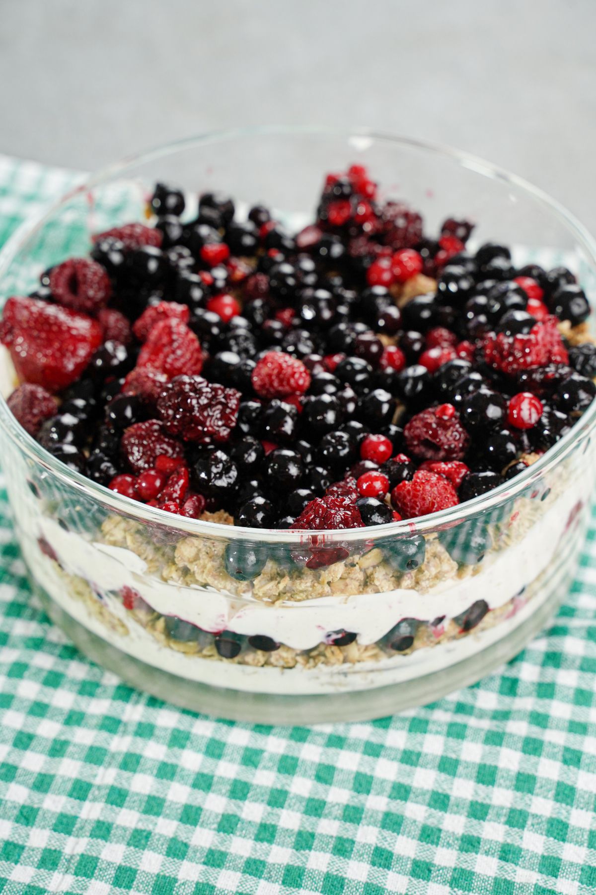 Creamy Layered Yogurt Fruit Parfait served on a green and white checks background