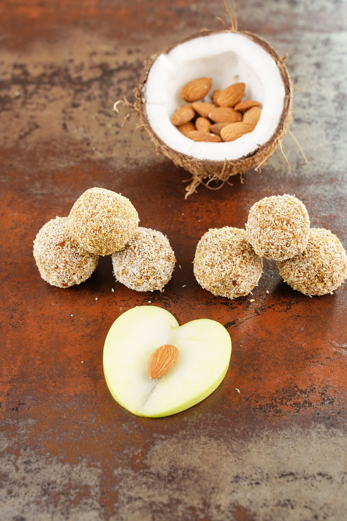 No-Bake Carrot Balls with coconut and avocado in the background