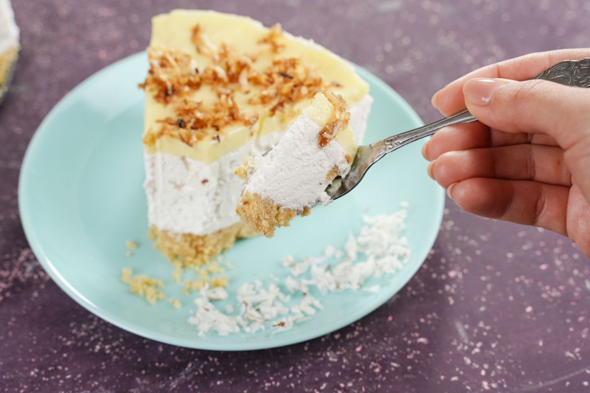 A piece of No-Bake Coconut Layered Dessert on a spoon