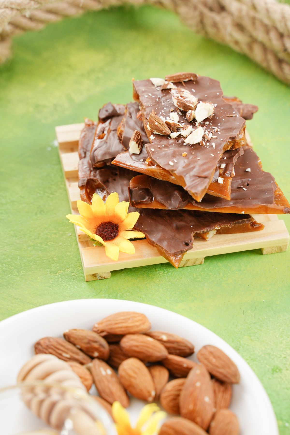 No-Bake English Toffee served on a wooden plater with sunflower