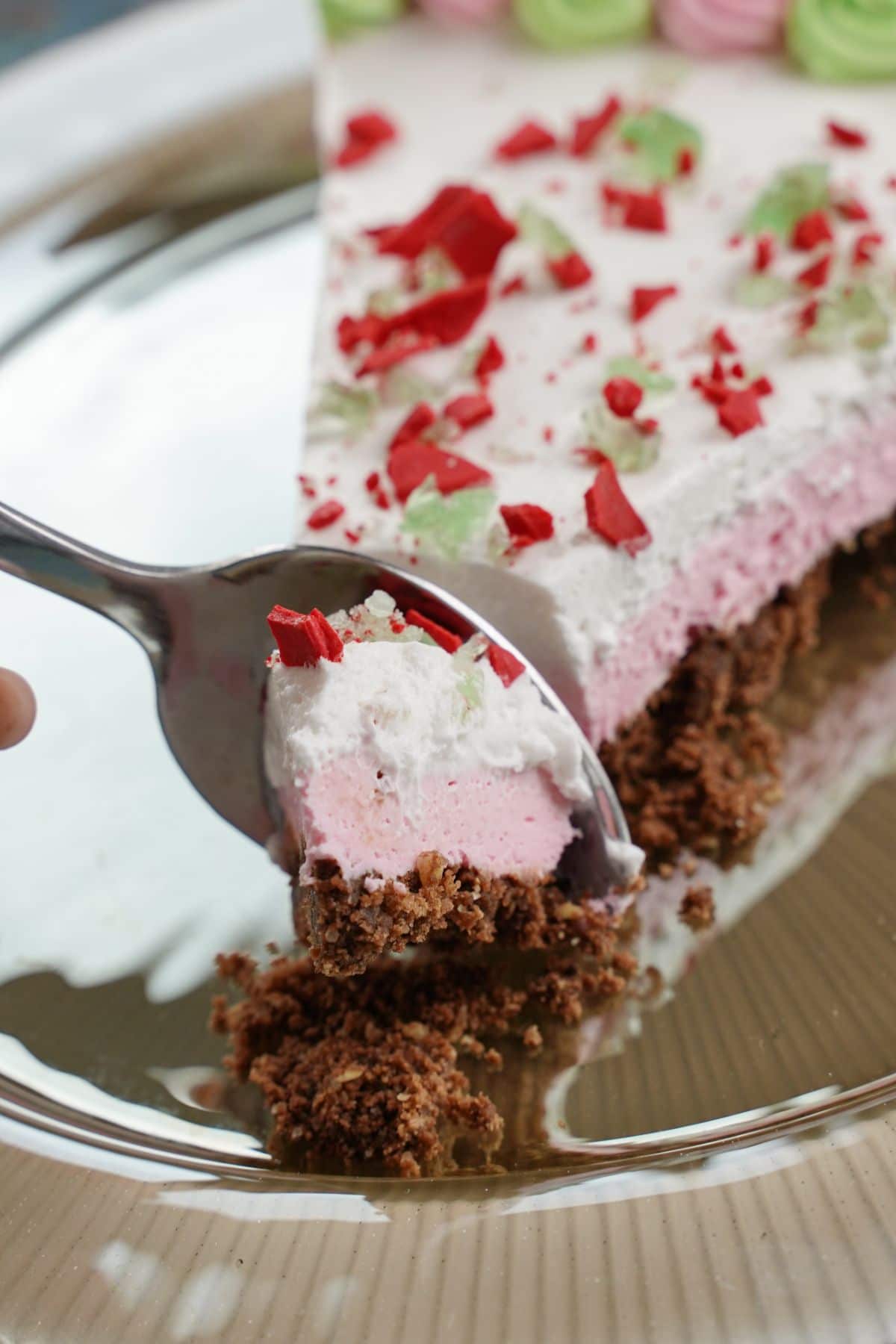 no bake peppermint pie cheesecake being served with a spoon
