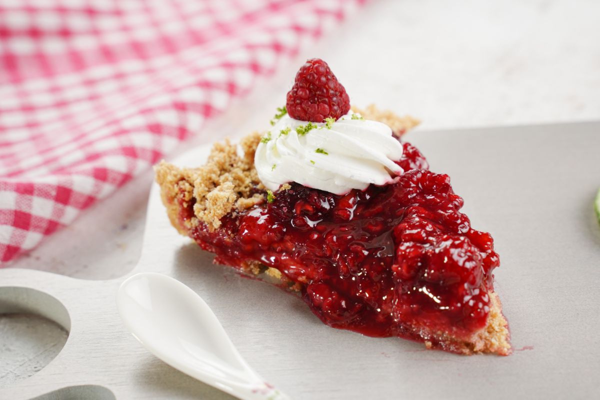 A slice of No Bake Raspberry Pie in a plate