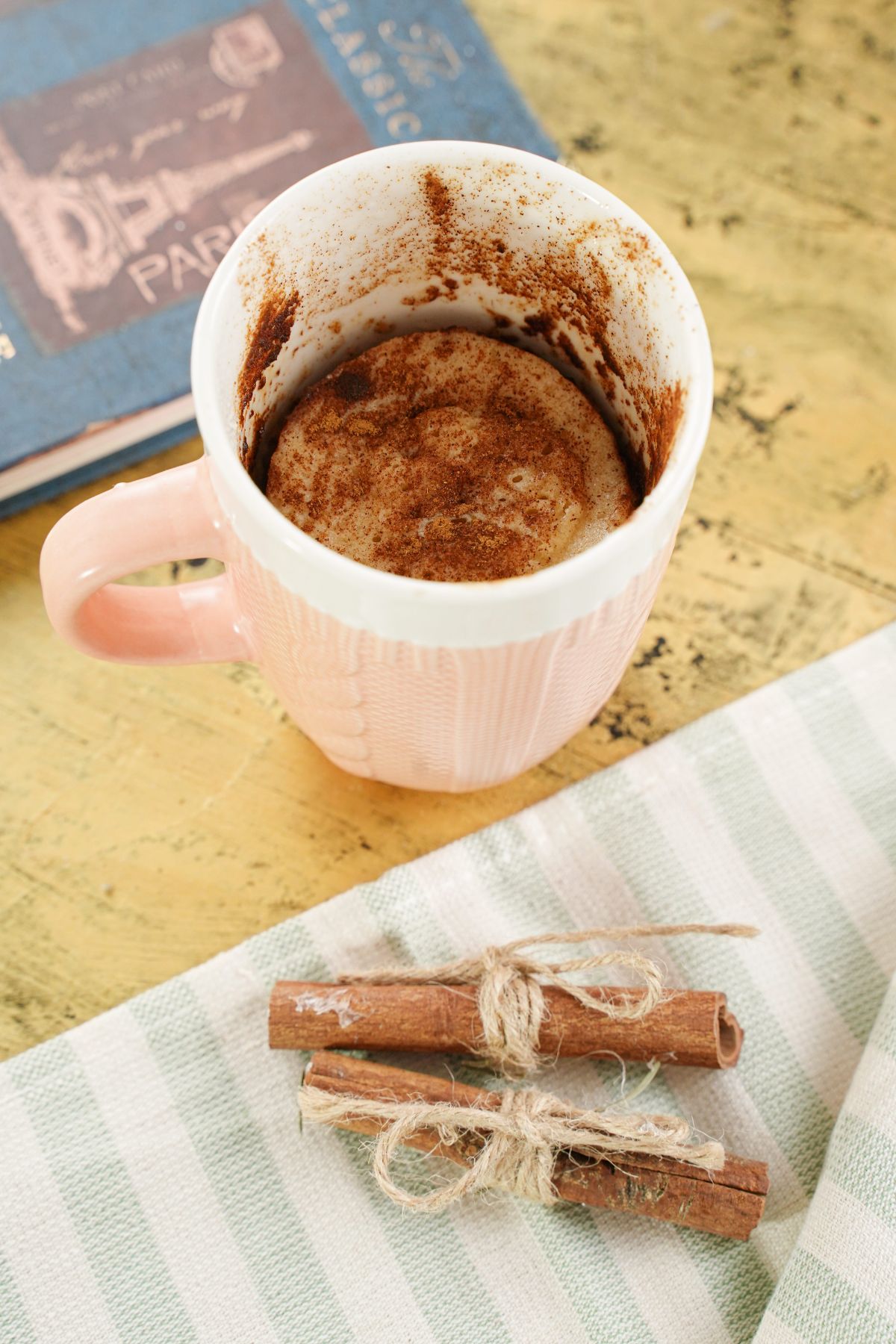 Microwave Snickerdoodle Mug Cake decorated with cinnamon stick