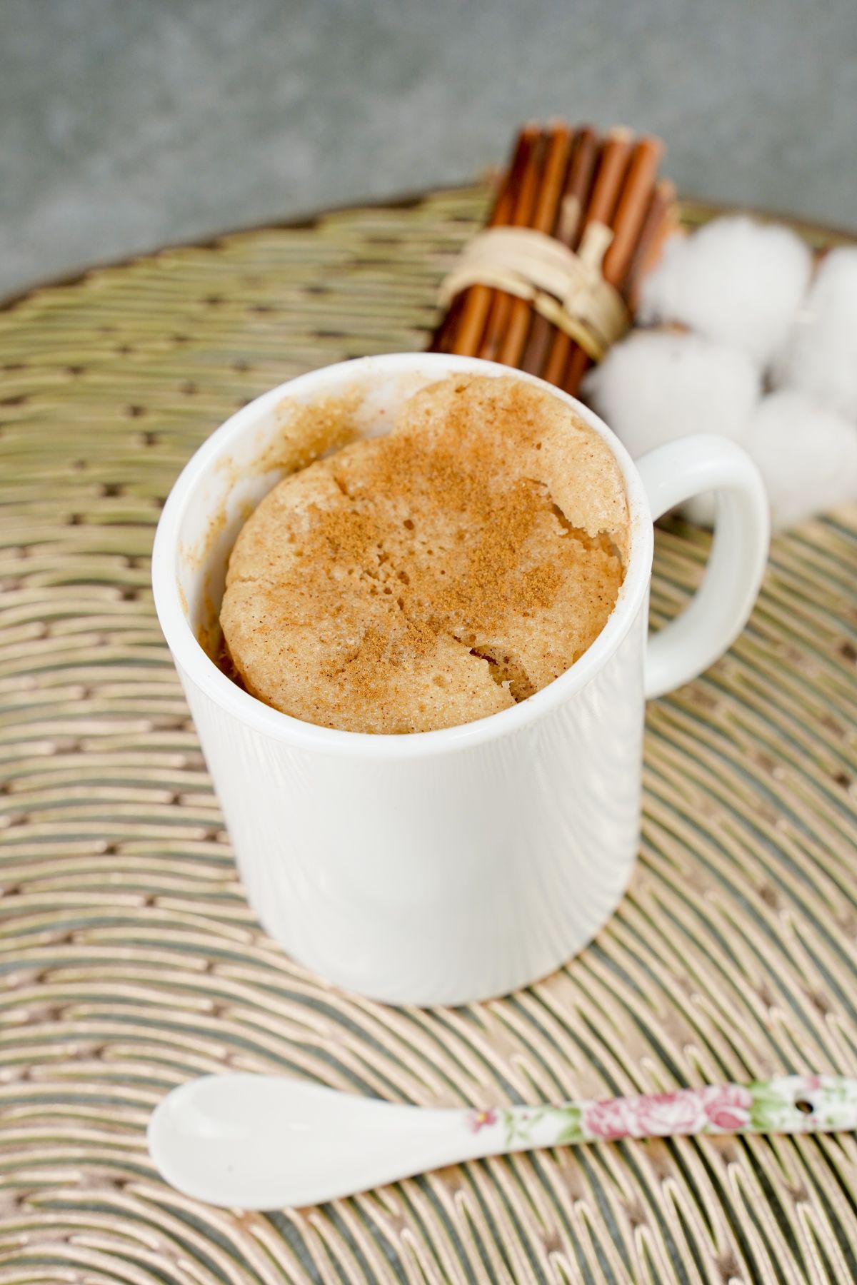 Microwave Snickerdoodle Mug Cake in a cup and a spoon