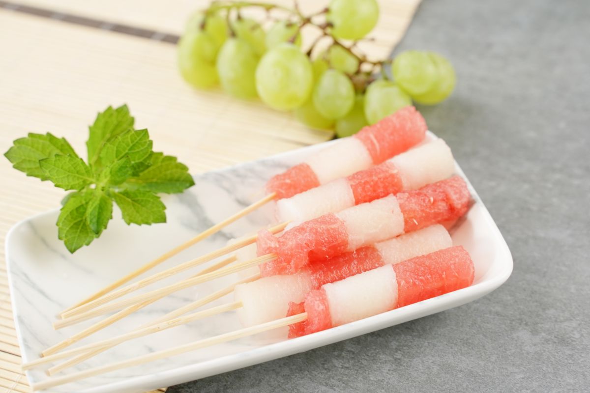 Juicy Summer Fruit Skewers is ready to enjoy with some mint leaves