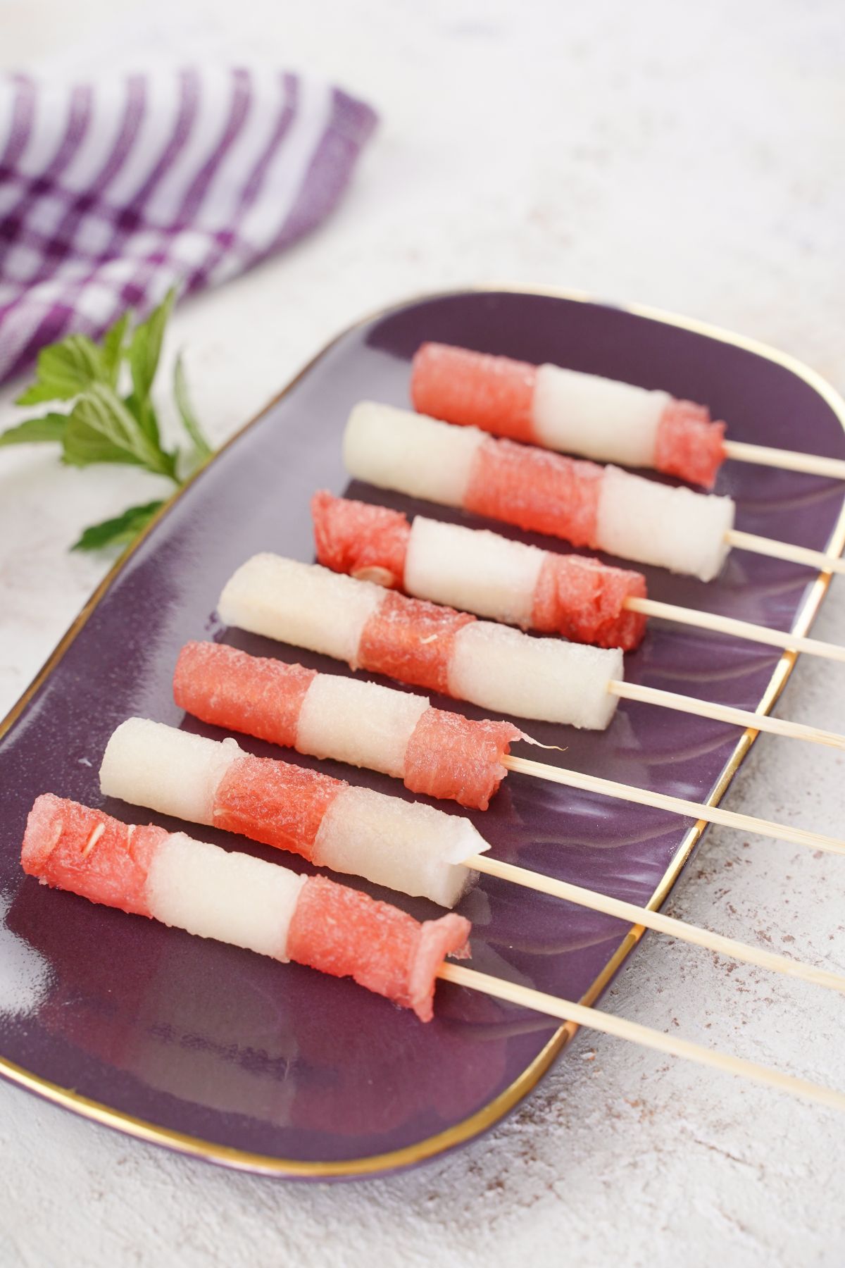 Juicy Summer Fruit Skewers with mint leaves