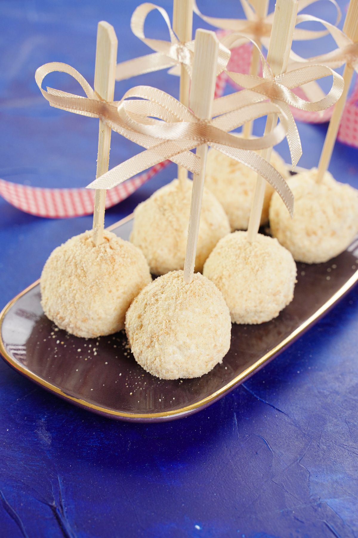 Side view image of White Chocolate Cheesecake Pops in a tray