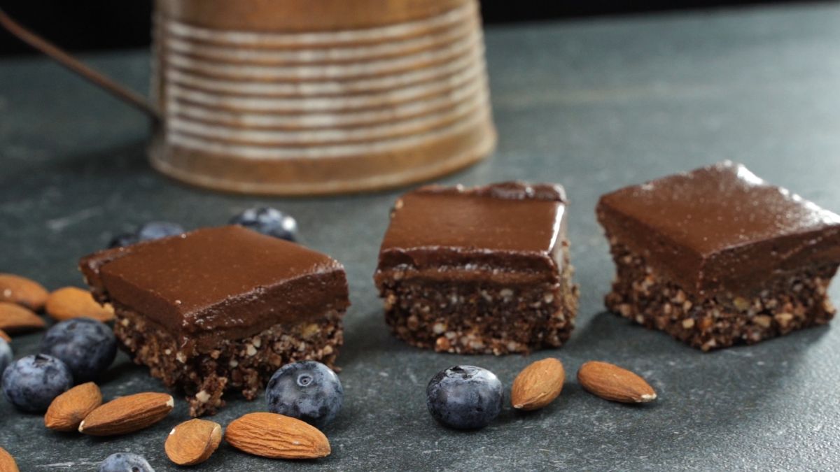 cut the Almond Butter Cup Bars into pieces and serve it with almonds and fresh blue berries