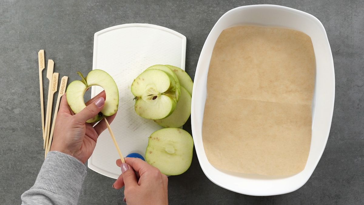 poke the sticks into the apple slices