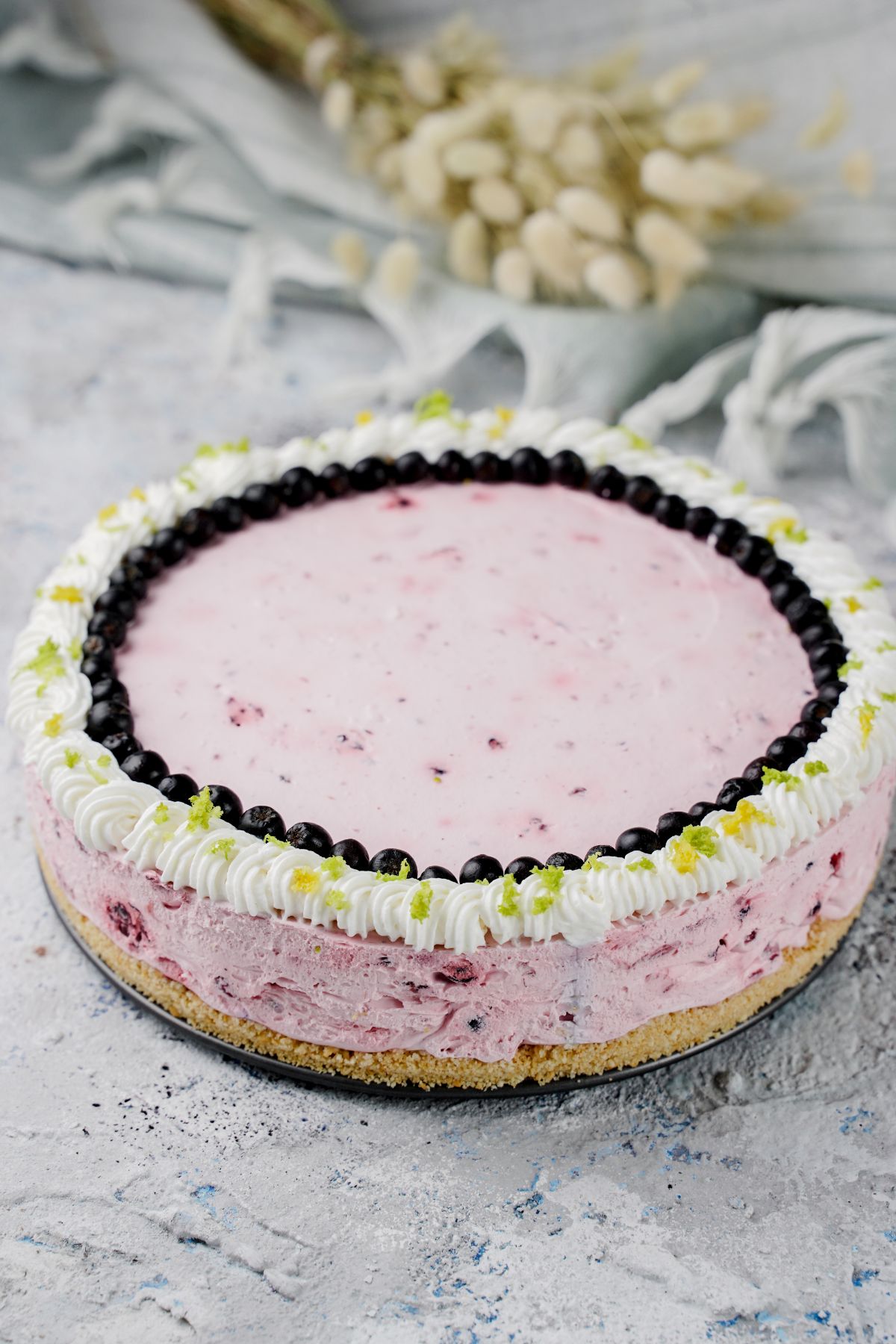 No-Bake Fruit Smoothie Cheesecake decorated with fresh berries on top