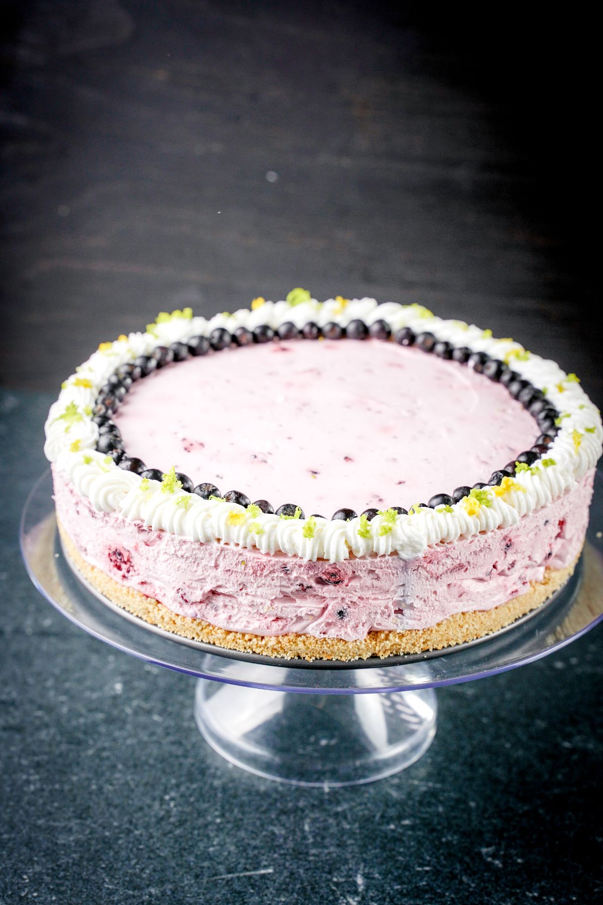 No-Bake Fruit Smoothie Cheesecake served on a glass cake holder