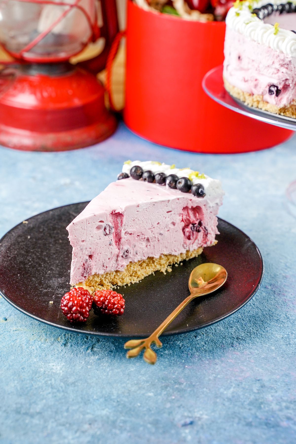 A piece of No-Bake Fruit Smoothie Cheesecake with golden spoon