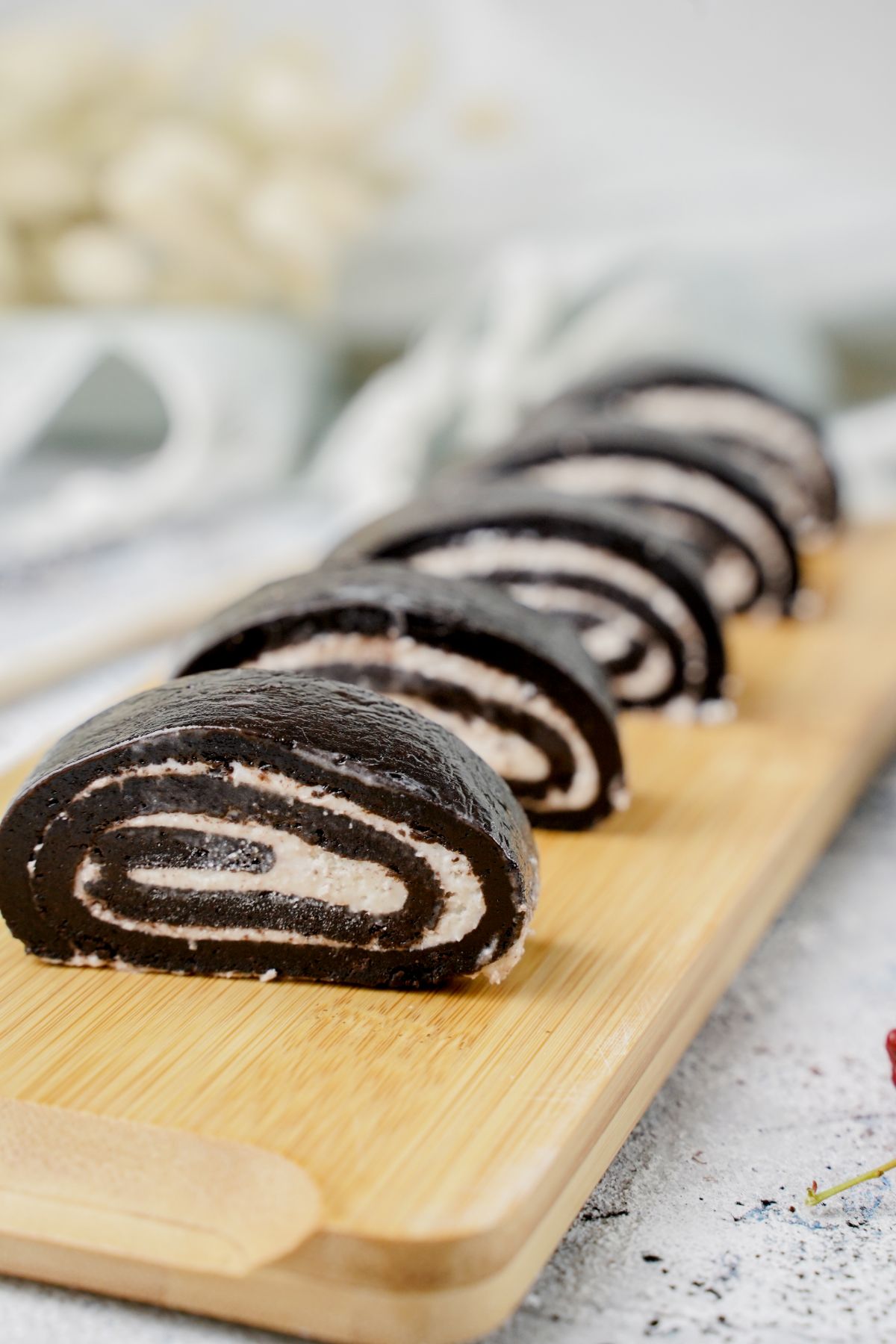 Side view image of No-Bake Oreo Sushi served on a wooden plater